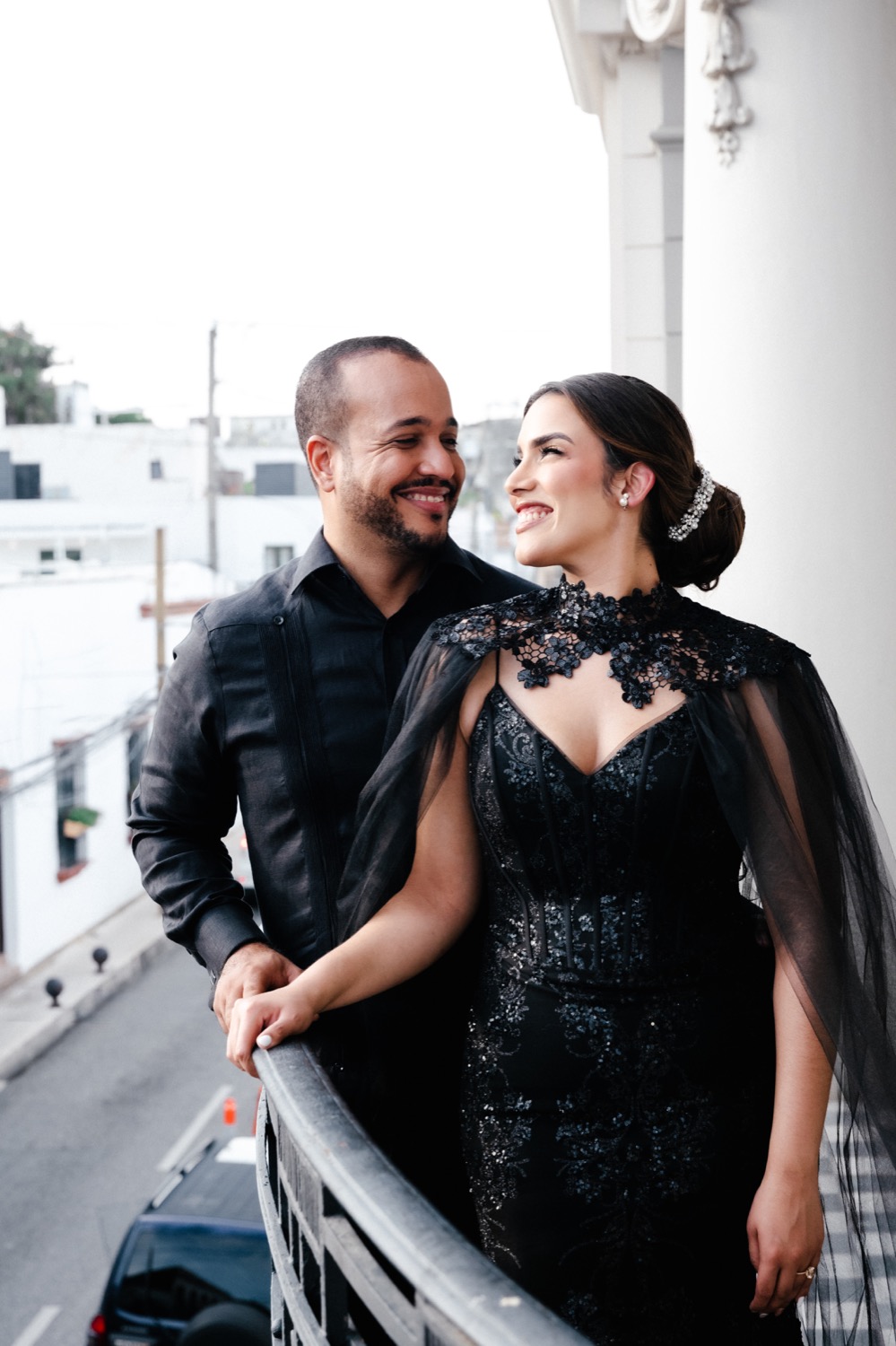 Camila y Hector sonriendo juntos en un balcón